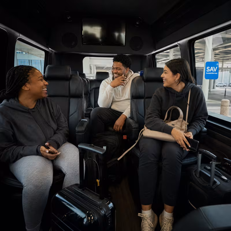 Passengers loading luggage while boarding an Savannah group shuttle