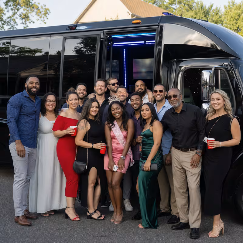 Group boarding a white charter bus for Birthday Transportation transportation in Savannah