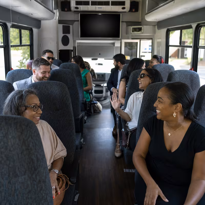 Group boarding a white charter bus for Private Event Transportation transportation in Savannah