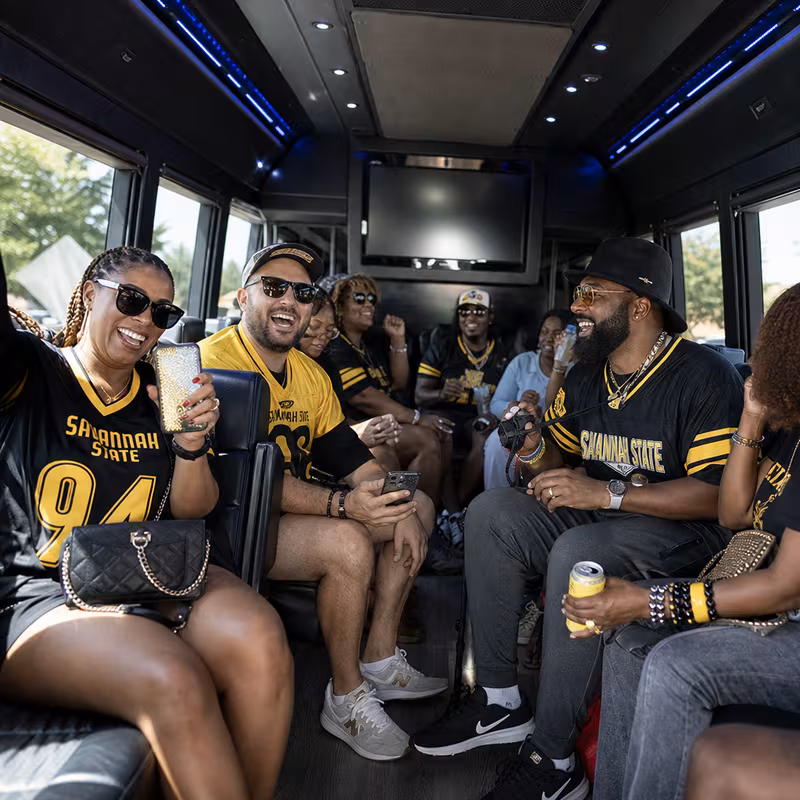 Group boarding a white charter bus for Sporting Event Transportation transportation in Savannah
