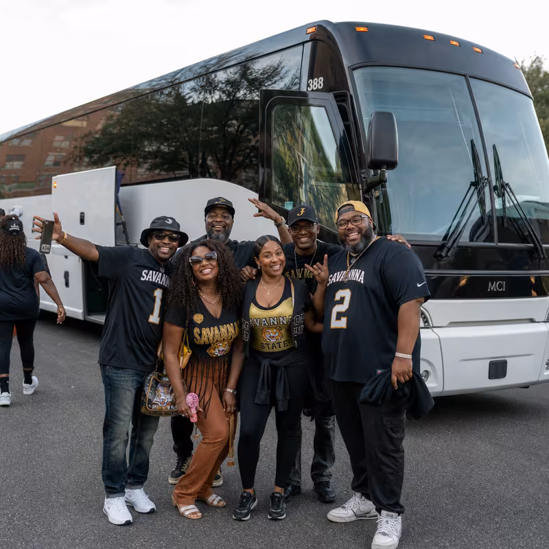 Passengers loading luggage while boarding an Savannah group shuttle