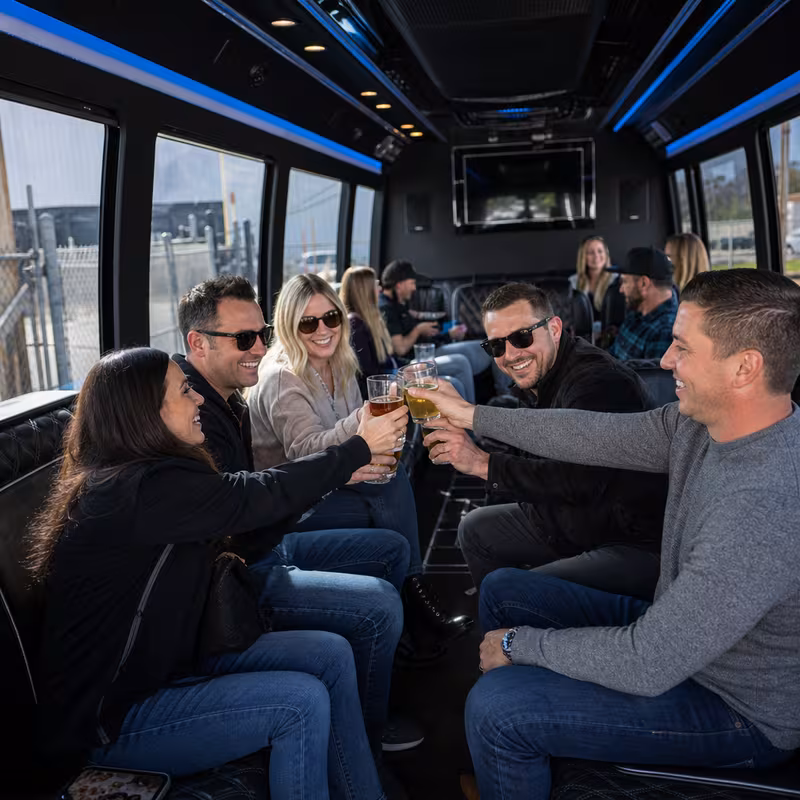 Group boarding a white charter bus for Winery & Brewery Tour Transportation transportation in Savannah